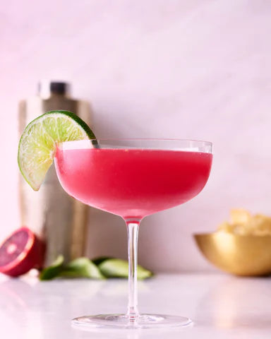 Blood Orange & Rosemary Vodka Cocktail with wedge of lime
